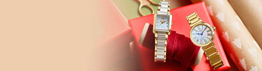 Image featuring two women's watches sitting on top of gift wrapping - Bianca watch model EW5554-58D and Citizen L Mae watch model EM1062-57D