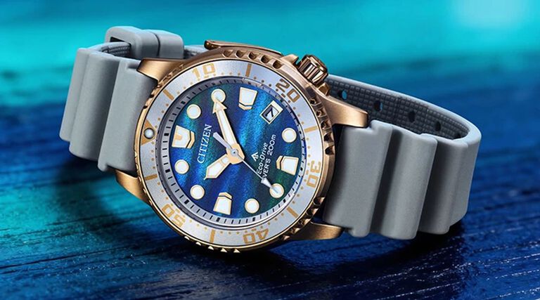 Women's Promaster Dive Watches; Image of Promaster Dive 37mm watch model EO2023-00W on a tabletop surface with various shades of blue