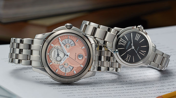 Graduation Watch Gifts; Featuring Calendrier watch model BU0080-52X and Ceci watch model EM1160-58E sitting on top of a book