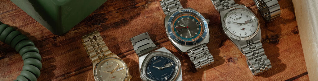 Image of various watches from the Citizen x Analog:Shift vintage watch collection sitting on a wood table