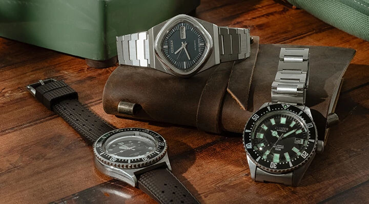 Image of various watches from the Citizen x Analog:Shift vintage watch collection sitting on a wood table