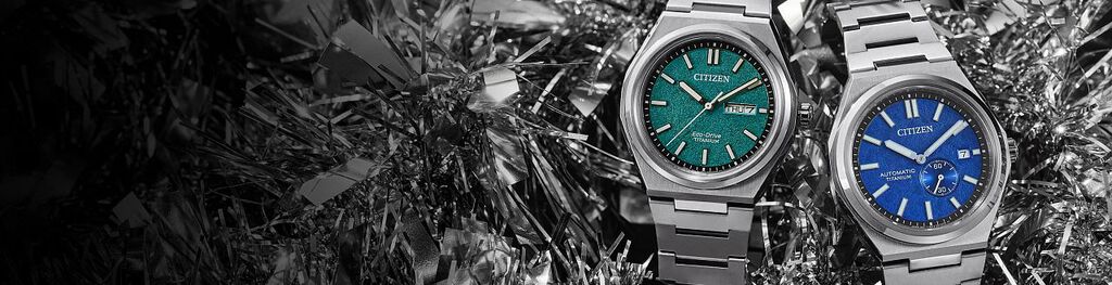 Zenshin Watches; Featuring an image of two Zenshin watch models AW0130-85X and NJ0180-80L on a silver holiday tinsel background