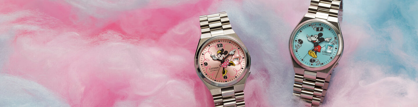 Disney watches featuring TSUYOSA Minnie Mouse and TSUYOSA Mickey Mouse watch models NJ0150-50W and NJ0156-50L sitting on cotton candy background