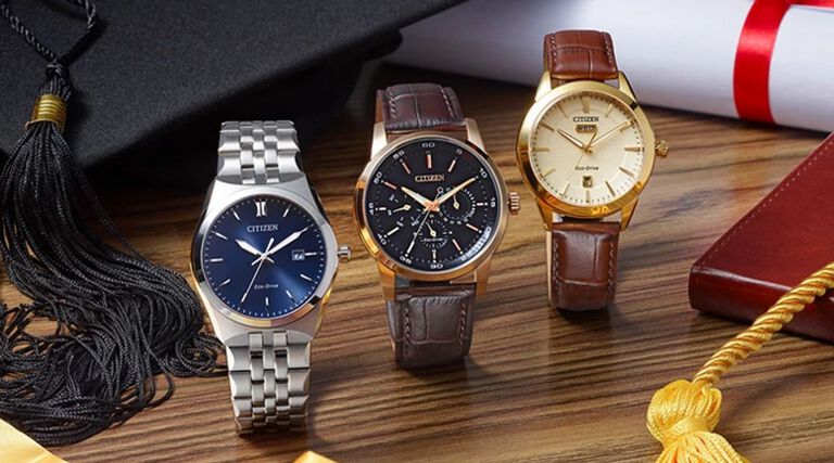 Graduation Watch Gifts; Featuring three Rolan and Corso watch models AW0092-07Q, BU2013-08E and BM7330-59L with a graduation cap, gown and diploma in the background