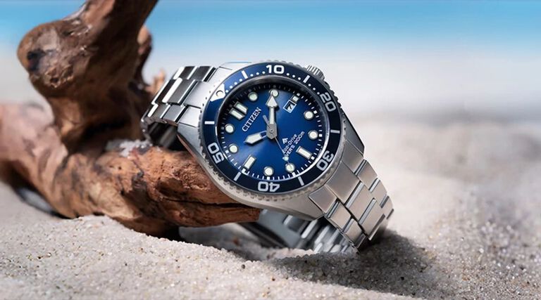 Men's Watches; Featuring an image of Promaster Dive watch model BN0260-54L on a sand background